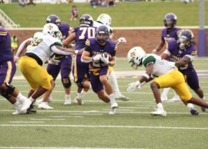 UMHB running back carrying the ball 